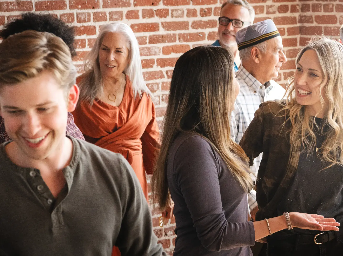 A group of people standing around each other.